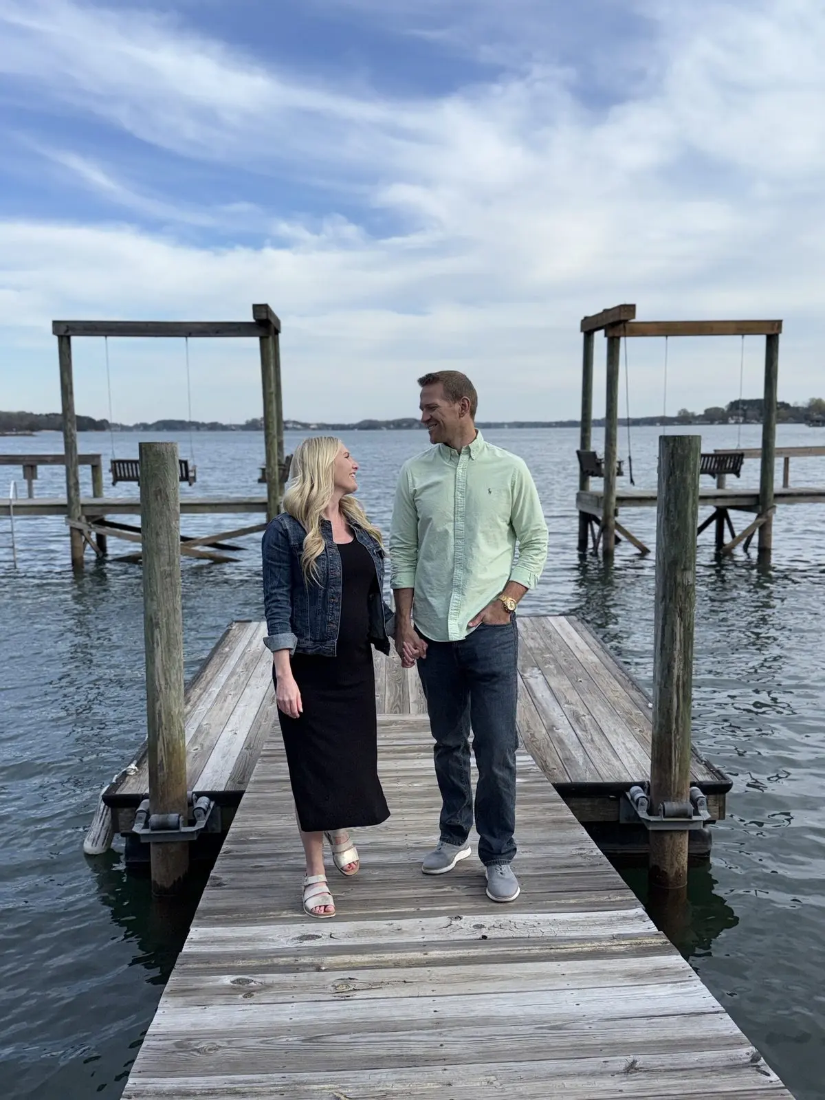 Couple walking on the Port Royale dock with lake swings